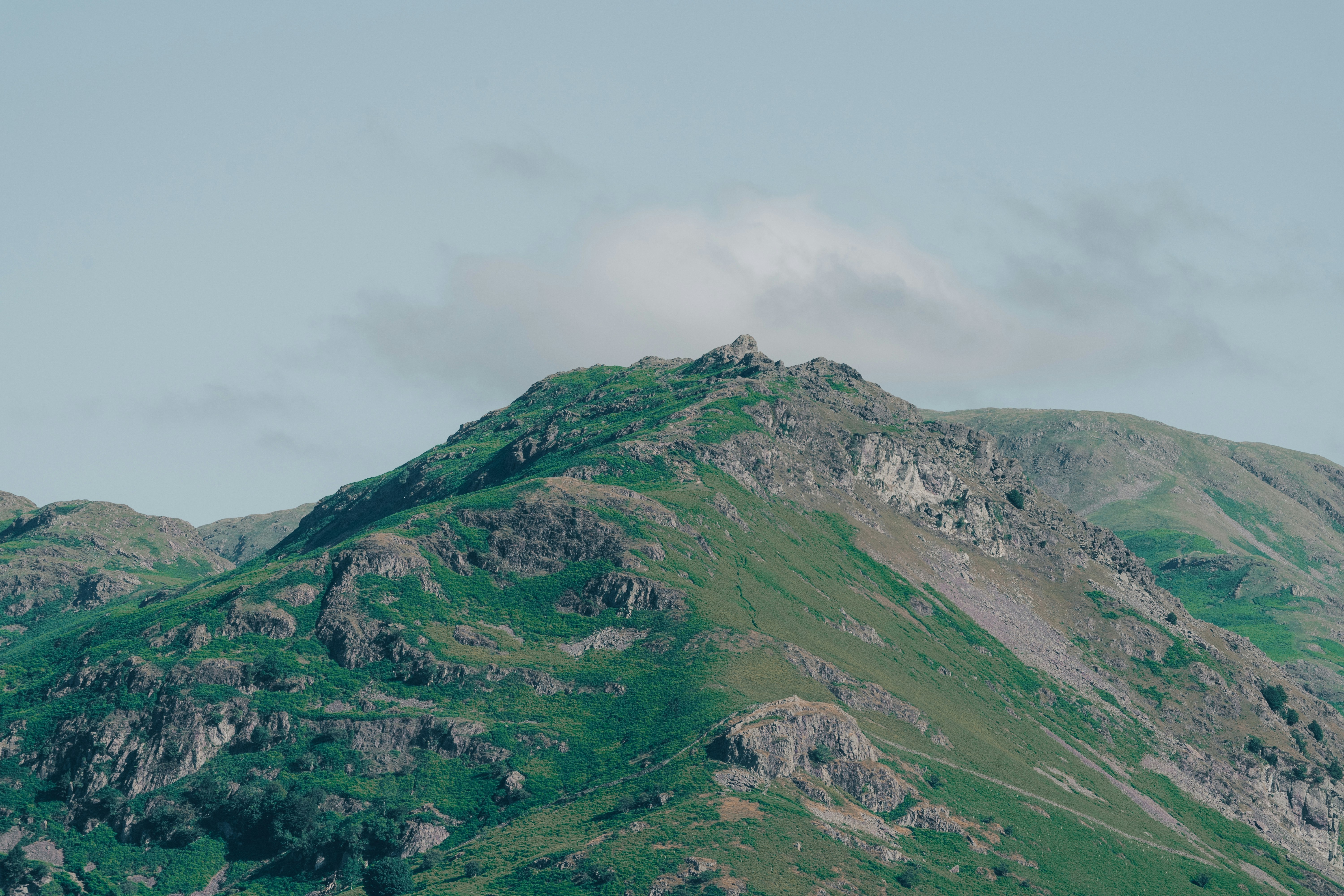 green and gray mountain under white sky during daytime